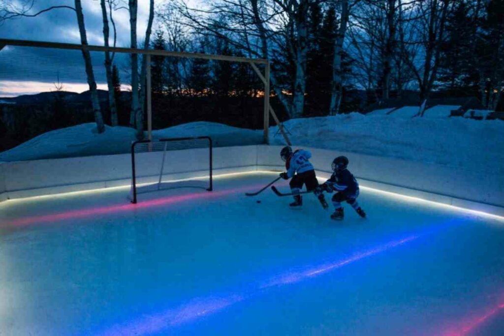 Backyard ice rink at night