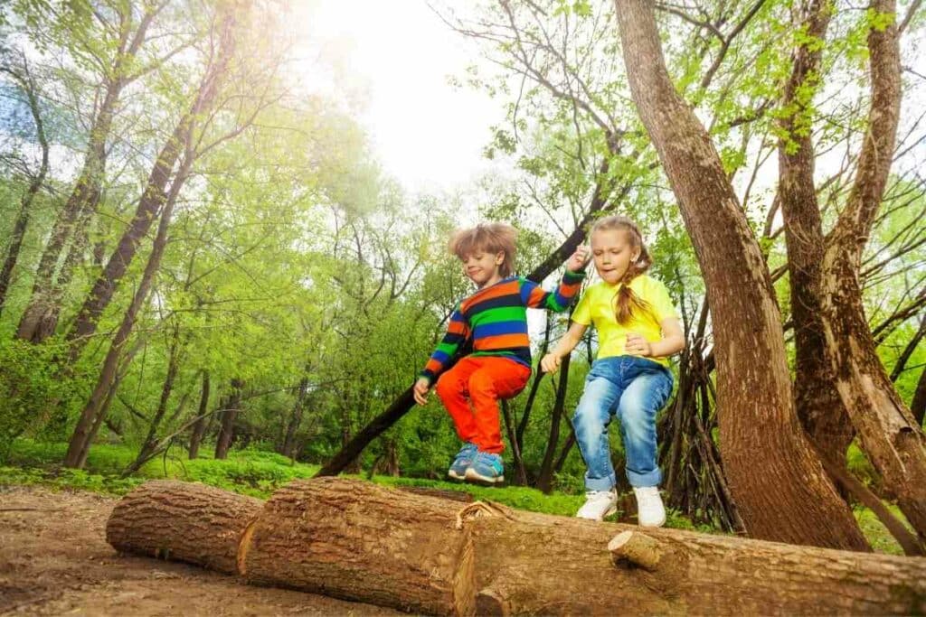 Kids having fun logs backyard