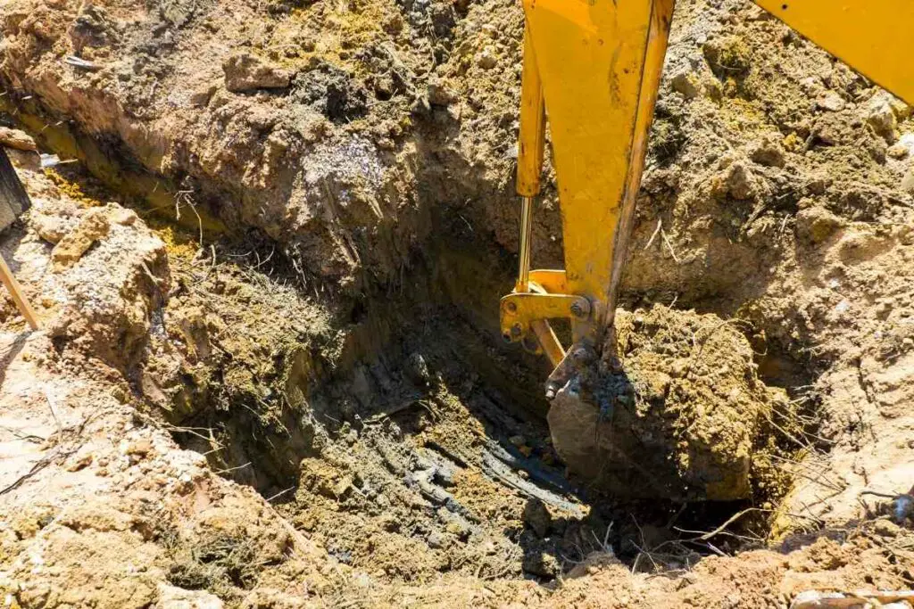 Mini excavator digging deep holes