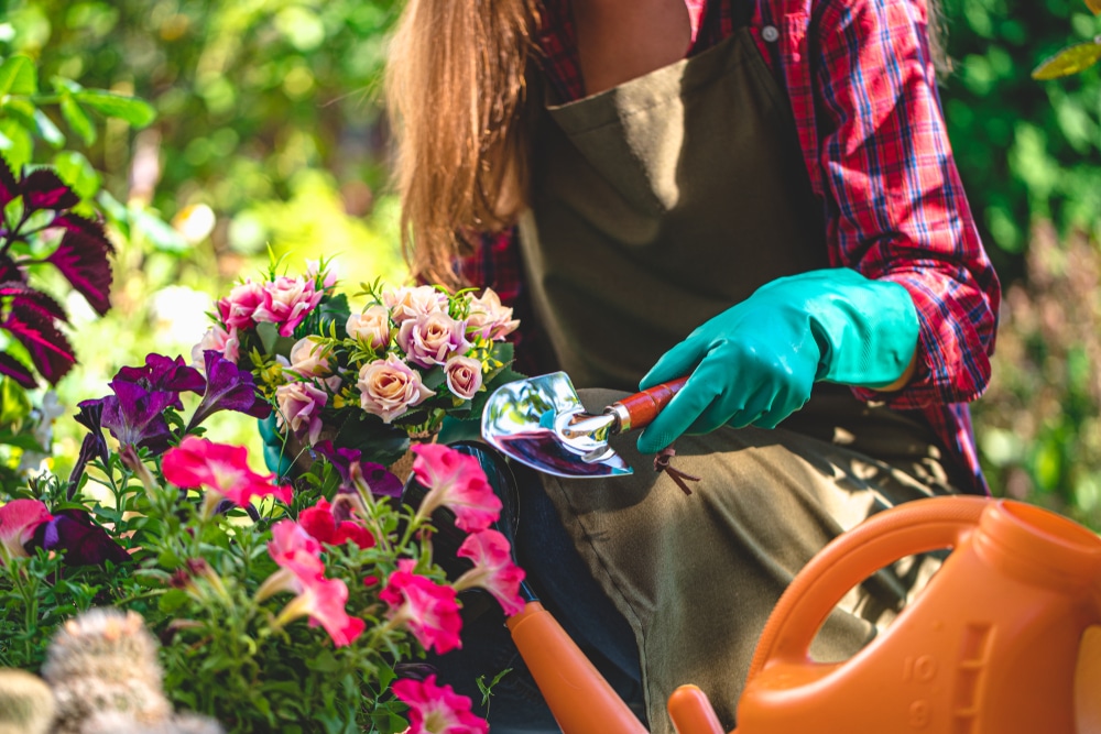 A woman tending some of her flowers.