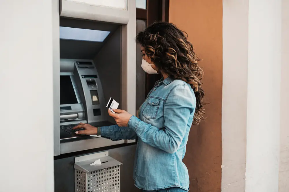 A woman at an ATM.