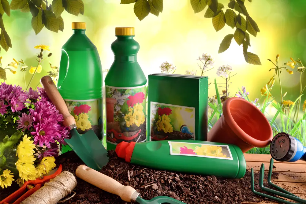 A collection of bottles of plant growth products and tools.