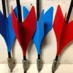 A closeup of vintage lawn darts in blue and red colors.