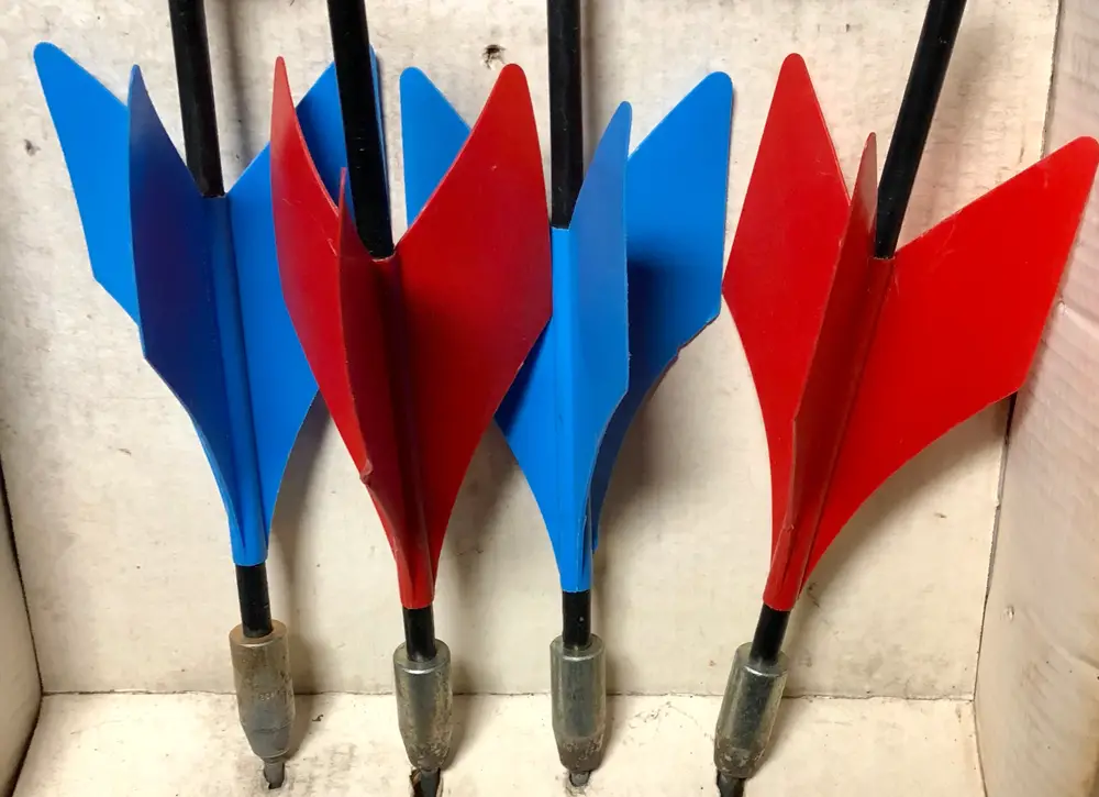 A closeup of vintage lawn darts in blue and red colors.