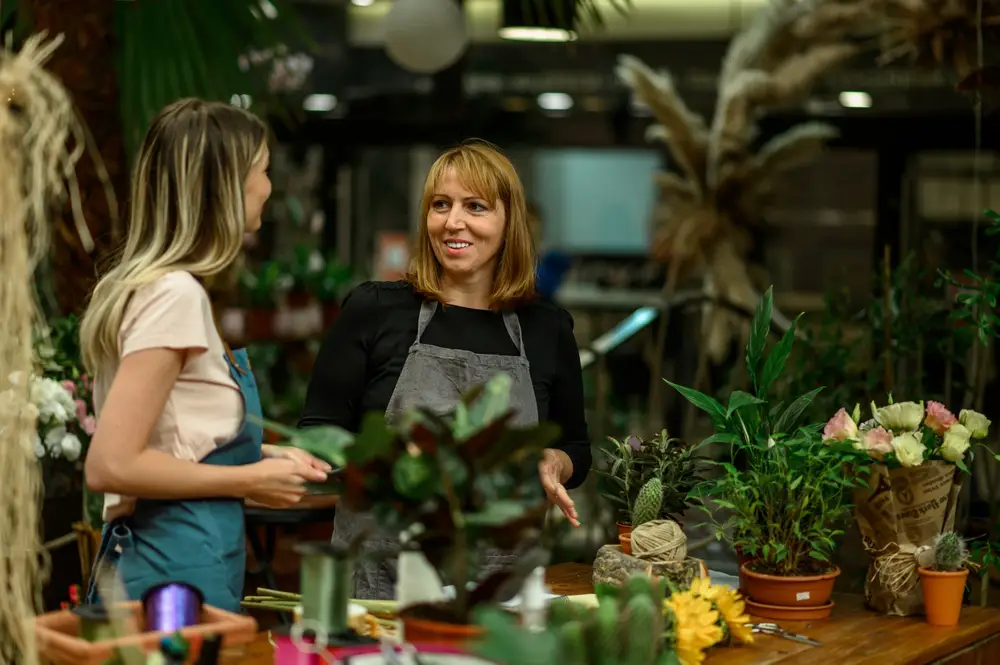 A female customer talking to a florist in her shop.
