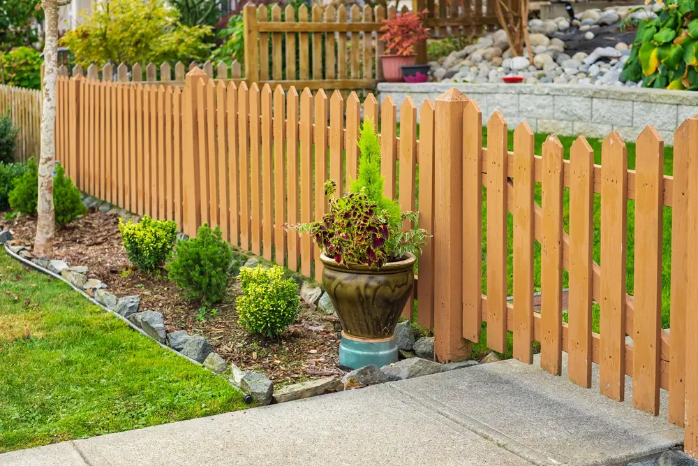 A small wooden fence surrounding a backyard.